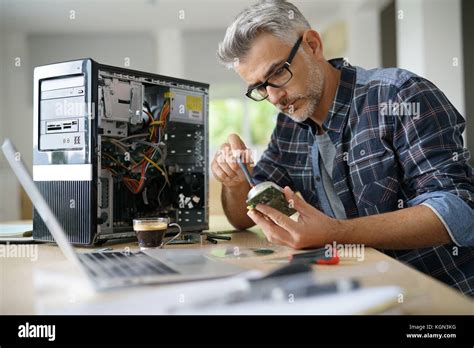 Technician repairing computer hardware Stock Photo - Alamy