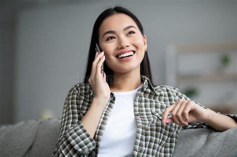 Happy Asian Woman Having Phone Conversation Home Interior Stock Image Image Of Joyful Happy