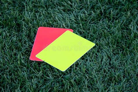 Referee Soccer Football Game Red And Yellow Cards On Green Grass Two