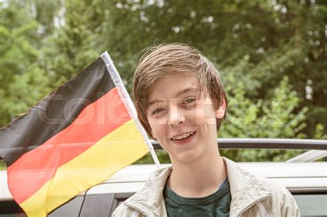 Smiling Male Teenager In Front Of A German Flag Stock Bild Colourbox