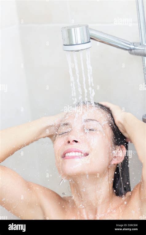 Beautiful Young Mixed Race Woman Washing Face And Hair Showering Under Shower Head In Bathroom