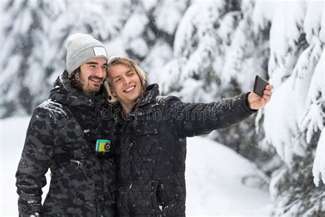 Young Man Couple Taking Selfie Photo In Snow Forest Outdoor Guys