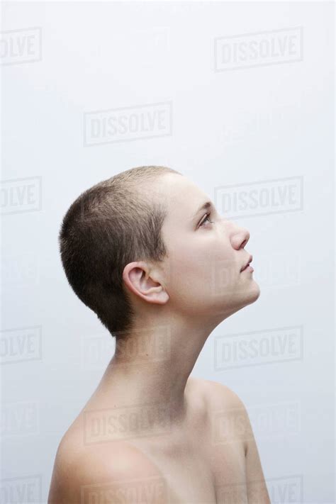 Woman With Shaved Head Looking Up Stock Photo Dissolve