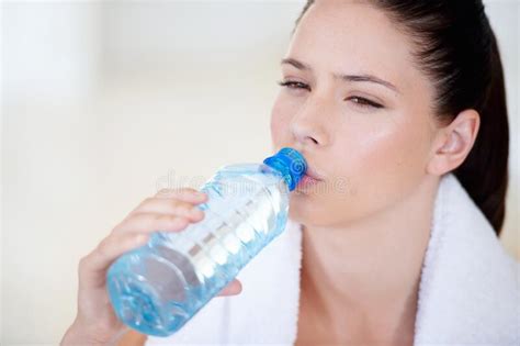 Staying Hydrated After A Workout Young Woman Drinking Water After A