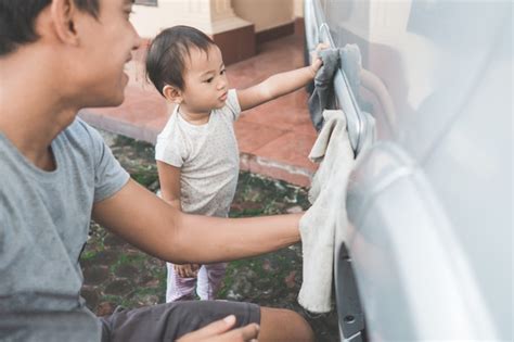 Premium Photo Child Helping Her Daddy Cleaning Up The Car