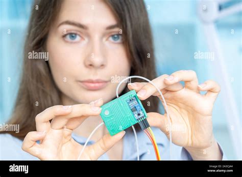 Young Scientist Woman In Microbiological Lab With Lab On Chip Loc