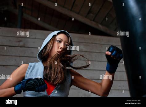 Female Boxer Kicking Punching Bag Hi Res Stock Photography And Images