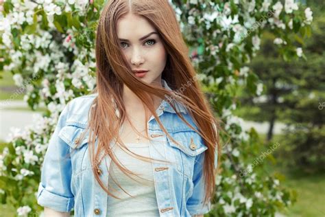 Beautiful Sexy Cute Sweet Girl With Long Red Hair And Green Eyes In A Denim Jacket Near A
