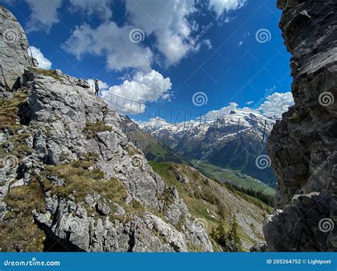 Pretty Female Climber On A Steep Via Ferrata In The Swiss Alps Stock