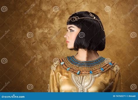 beautiful woman like egyptian queen cleopatra on golden background side view face profile