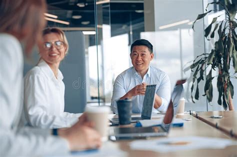 Young Asian Businessman Listening His Colleagues On Meeting In Modern