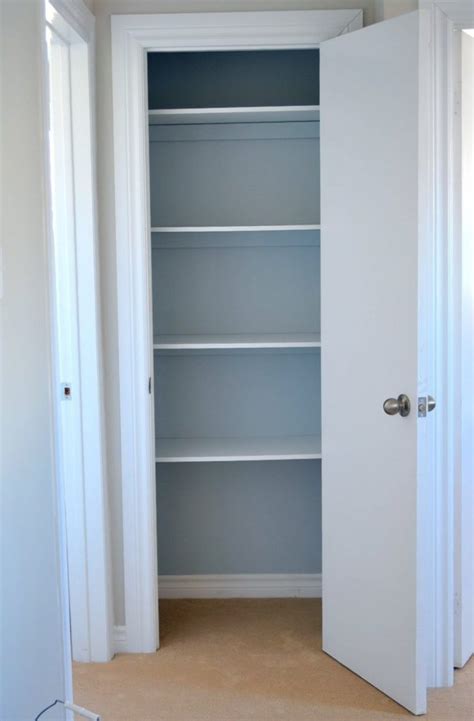 A curved built in linen cabinet is fitted with glass front cabinets flanked by white drawers adorned with polished nickel pulls and white overhead cabinets. Linen Cabinet Wood Working Plans | Linen cabinet, Wood cabinets, Closet planning