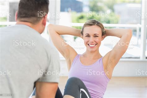 Trainer Helping Woman Doing Sit Ups Stock Photo Download Image Now