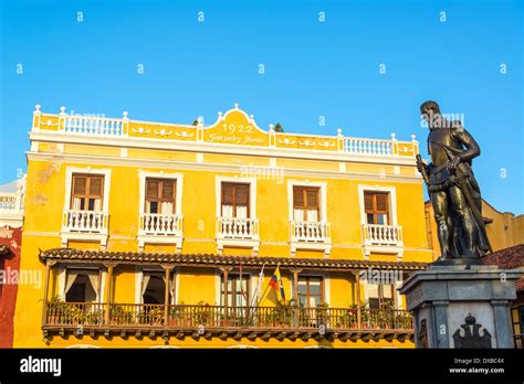 Yellow Colonial Building In Cartagena Colombia With A Statue Of Pedro