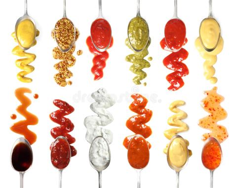 Set Of Spoons With Different Delicious Sauces On Background Top View