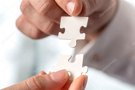 Two Businesspeople Fitting Together Puzzle Pieces — Stock Photo © Gajus