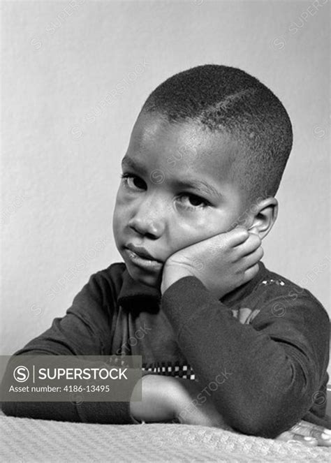 Portrait Of Sad Unhappy African American Boy Head Resting On Hand