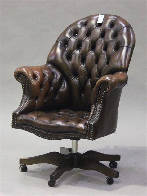 A Modern Brown Buttoned Leather Revolving Office Chair With Brass
