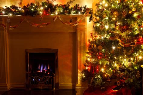Decorations On A Christmas Tree Near A Fireplace by Petr Kratochvil