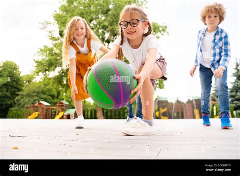 Multiracial Group Of Kids Playing At Playground During Break Playful