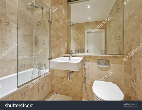 Modern Bathroom With Light Brown Marble And Natural Stone Tiles Stock