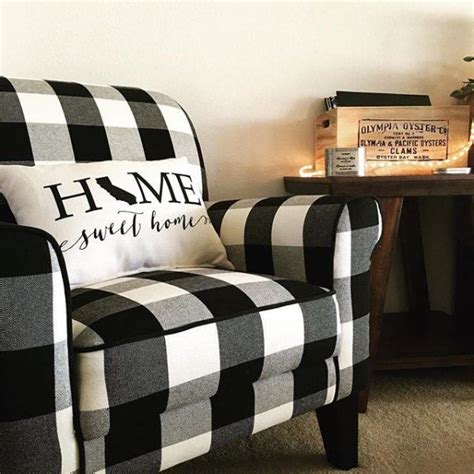 A Black And White Checkered Chair With A Pillow That Says Home Sweet Home