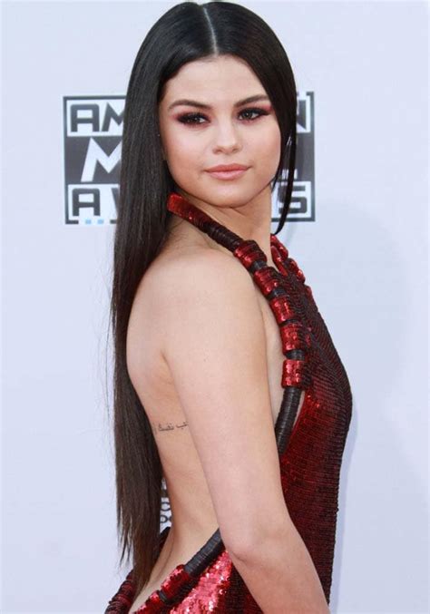 Its the number 76 in roman numerals, its 'dedicated to a close family member'. What's The Meaning Of Selena Gomez's Arabic Back Tattoo?