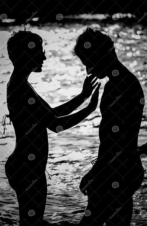 Silhouettes Of Couple Man And Woman In The Sea At Sunset Stock Image Image Of Relationship