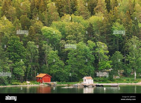 Sweden Beautiful Red Swedish Wooden Log Cabin House On Rocky Island