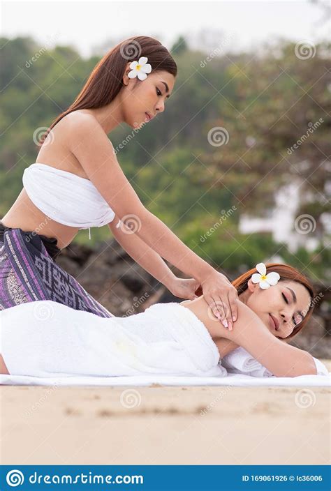 Beautiful Asian Woman Enjoying Spa Massage Therapy On The Beach Stock