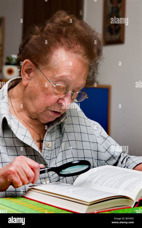 Old Woman With Glasses Reading A Book Stock Photo Alamy