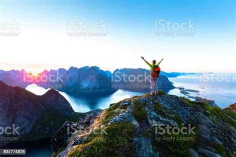 Hiker Enjoying Midnight Sun During Arctic Summer Reine Lofoten Norway