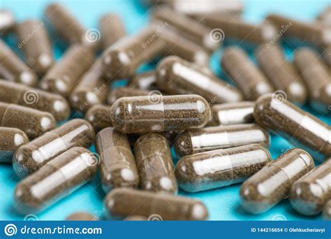 Brown Pills Tablets On Blue Background Close Up Photography Of