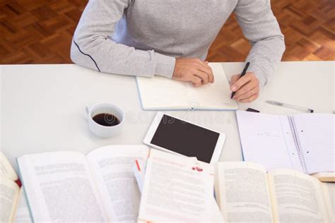 Close Up Of Man Sitting At Table With Books Stock Photo Image Of