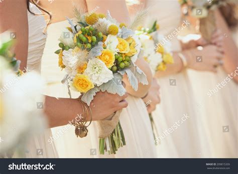 Bridesmaids Holding Bouquets During Wedding Ceremony Stock Photo