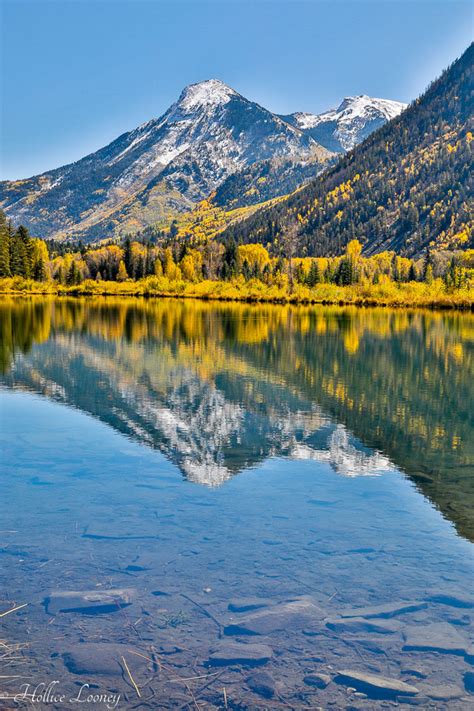 Reflection Of Snow Capped Mountains And Fall Color In The Lake Our
