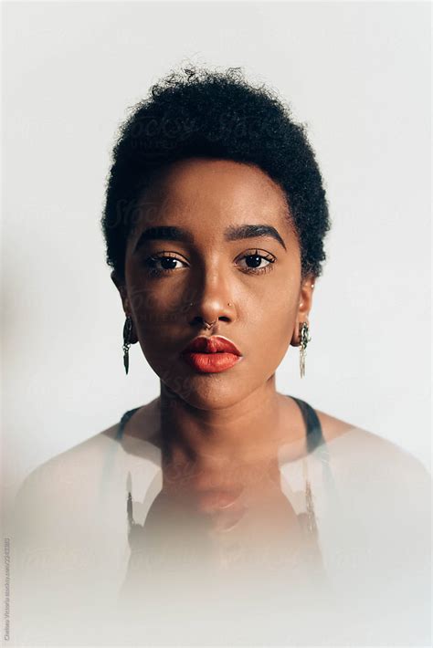 Portraits Of A Beautiful Young Black Woman Against A White Wall By