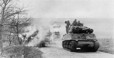An M4a3e2 Sherman Jumbo Leads An Armoured Column From 6th Ad Into