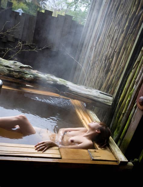 Japanese Woman Relaxing In Onsen Bath With Breasts