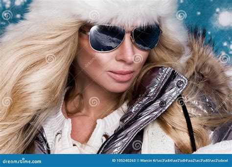 beautiful stunning woman with long blond hair and perfect face dressed in winter clothing