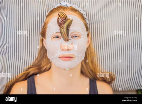 Young Woman Makes A Face Mask With Snail Mucus Snail Crawling On A