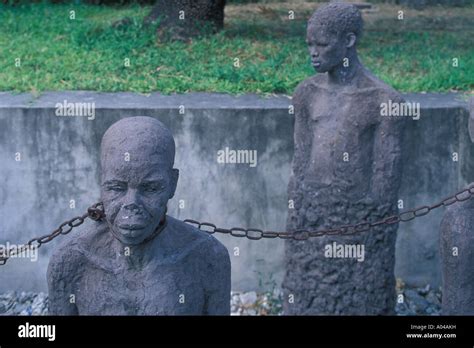 africa tanzania zanzibar stone town sculpture of chained slaves stands as memorial at site of