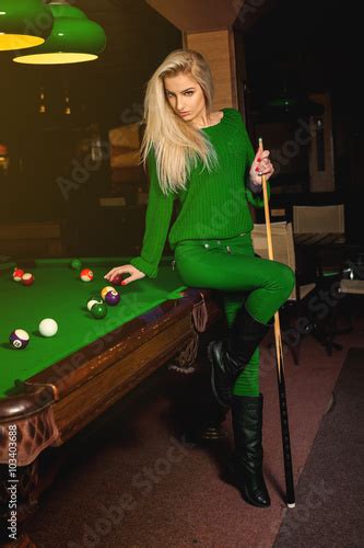 Sexy Beautiful Fashion Model Posing With The Cue On Pool Table Stock