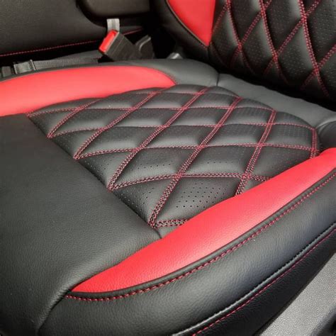 The Interior Of A Car With Red Stitching And Black Leather Upholsters