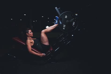 fit woman doing leg press exercise in the gym high quality free stock images