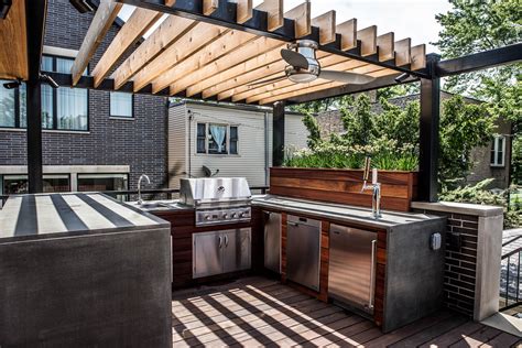 An outdoor kitchen is an excellent way to equip your backyard for entertaining and feeding hungry friends and family. This garage roof deck shows how a contemporary twist on ...