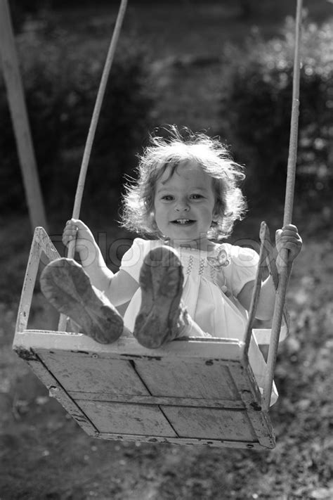 Child Playing On The Swings Black And White Photo With