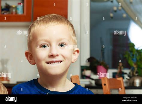 Portrait Of Happy Smiling Blond Boy Child Kid Making Silly Face At Home