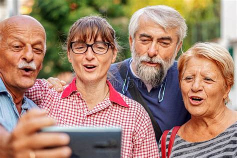 Elderly Couples Taking Selfie With Smartphone Old Friends Reunion