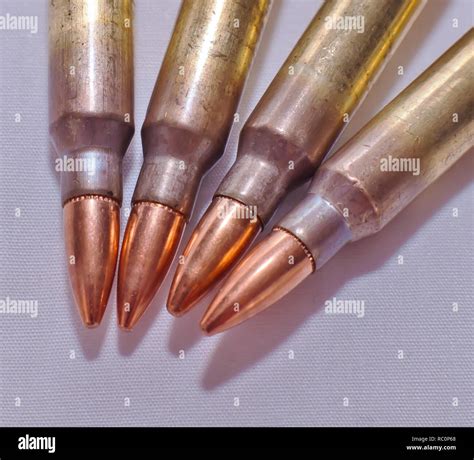 Four 223 Caliber Rifle Bullets On A White Background Stock Photo Alamy